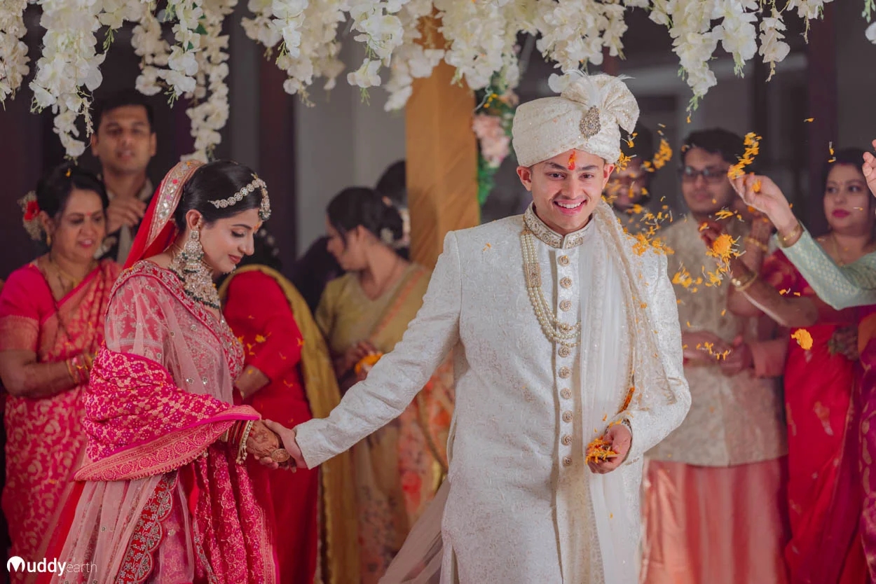 Bride and groom holding their Indian wedding album.
