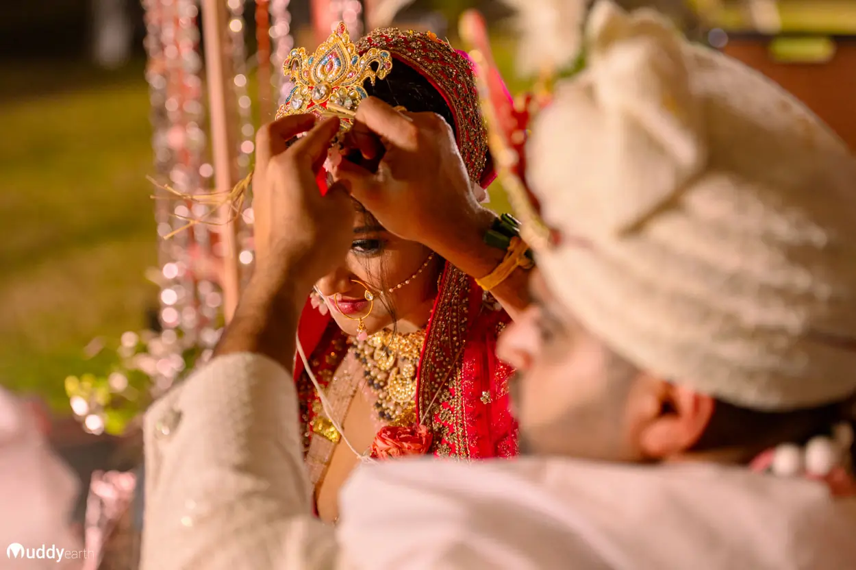 Bride and groom taking part in a traditional wedding ritual