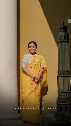 Bride in yellow outfit during haldi ceremony in Kolkata
